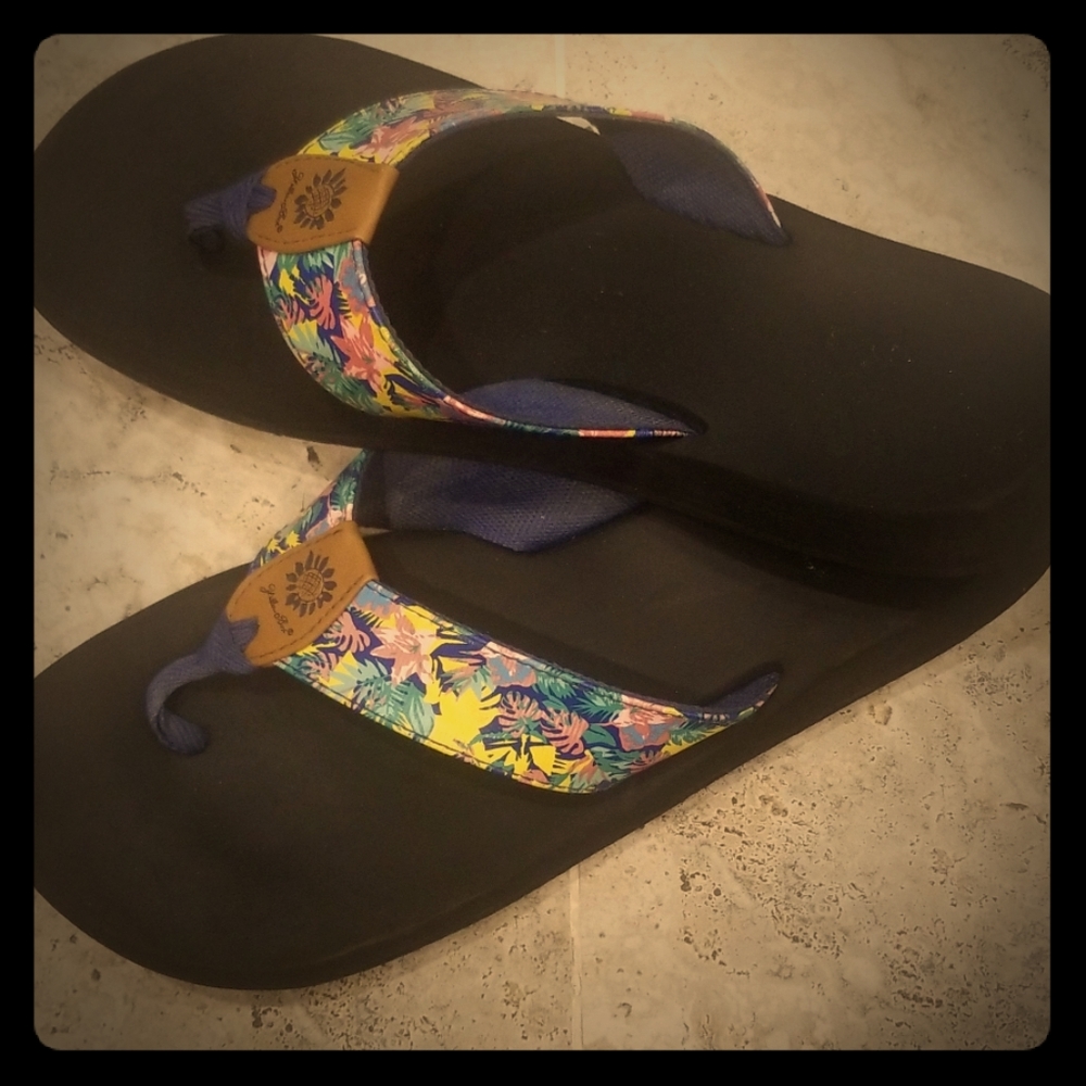 Well loved tropical themed Yellow box flip flops.